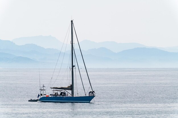 A lonely sailboat anchored inside the Ria de Pontevedra in Galicia on a foggy spring day