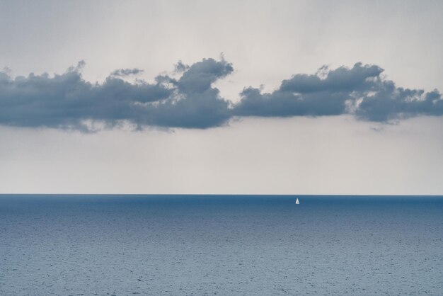 Photo a lonely sailboat in front of ventimiglia liguria italy