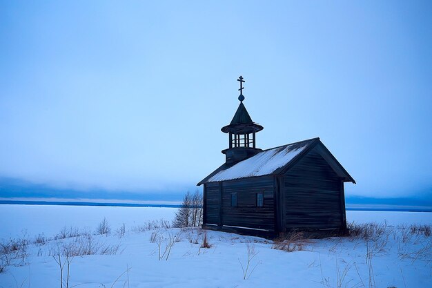 Lonely wooden church in the field concept faith god loneliness architecture in the winter landscape