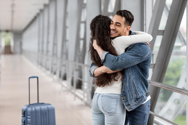 Long awaited meet happy arab man hugging girlfriend at airport after arrival