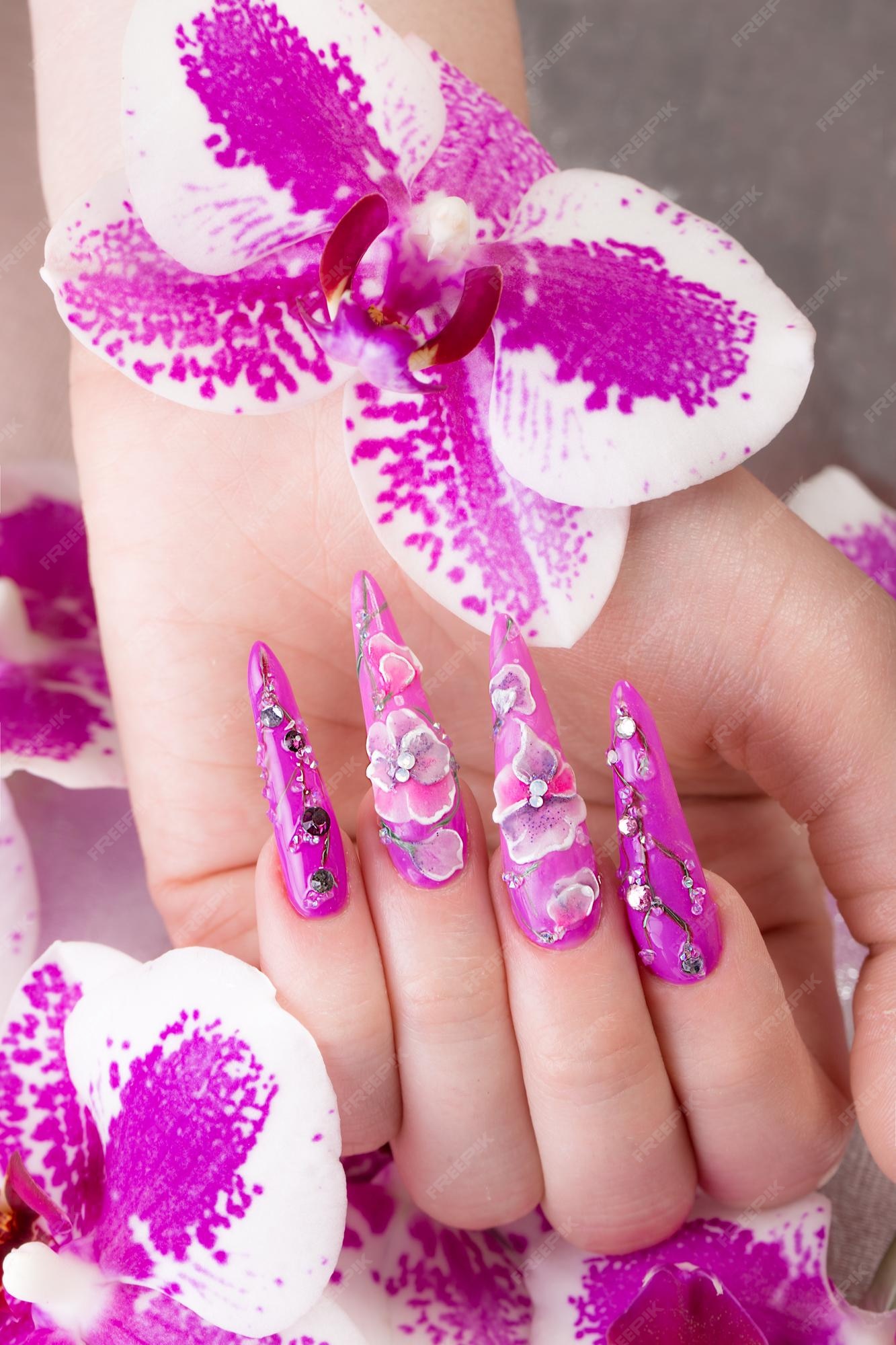 Premium Photo | Long beautiful manicure with flowers on female ...