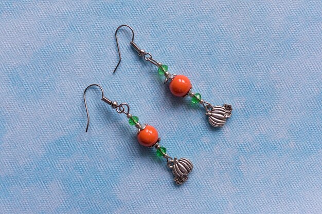 Photo long earrings with orange beads and pumpkin pendands