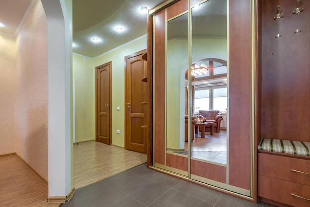 Long empty corridor in interior of entrance hall of modern apartments office or clinic with many doors