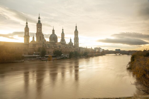 Long exposure at dusk of the Basilica of Our Lady of the Pillar from the Ebro river in the city of Zaragoza, Aragon. Spain