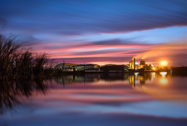 Long exposure landscape sunrise sugar factory Smokestack in factory, polution.