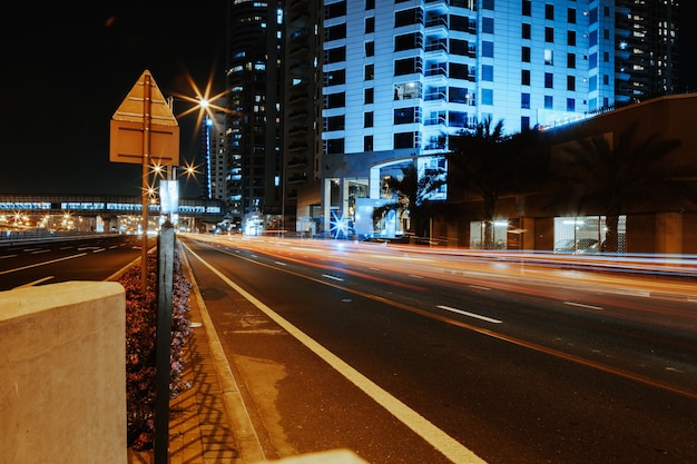 Long exposure of moving cars on night road in dubai