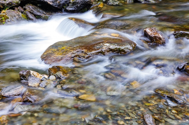 Длинное воздействие речного потока в горной долине Медленное движение поверхности кипящей воды в горной реке Свежая вода, пузыряющая из источника