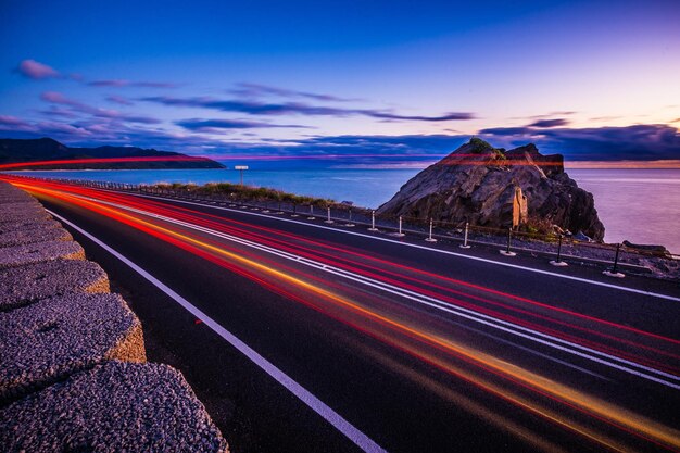 Long exposure of vehicles moving on road during sunset