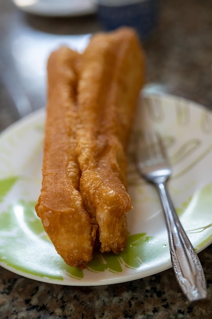 Long golden brown deep fried dough strip