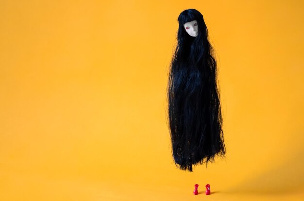 Long hair female ghost doll flying in the air with red high heel minimal halloween concept