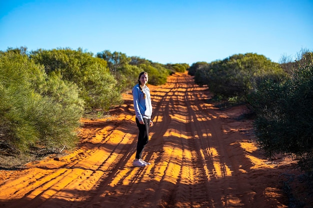 long-haired girl hiking in australian red sand desert terra rosa in francois peron national park