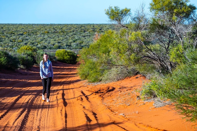 long-haired girl hiking in australian red sand desert terra rosa in francois peron national park