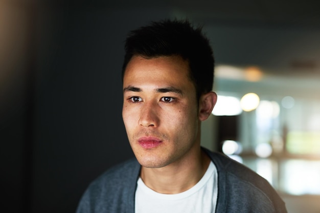 Long hours are sometimes required Shot of a handsome young male programmer working late in his office