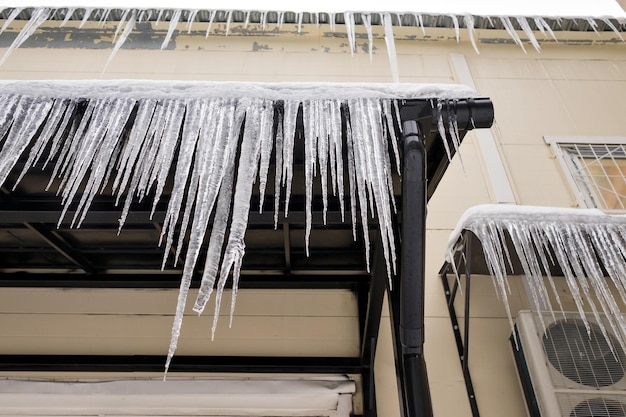 Long icicles fall from the roof on winter and early spring