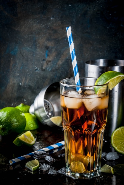 Long island iced tea cocktail with strong alcohol, cola, lime and ice