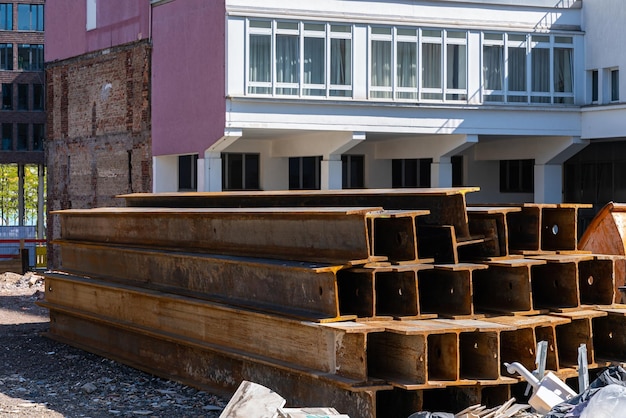 Long metal beams covered with rust lying on a construction site