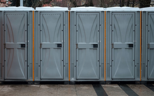 Long row of mobile bio toilets outside in the city.