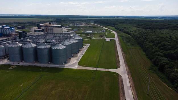 long rows of huge white gas tanks connected with pipeline system at refinery plant on sunny day aerial view.