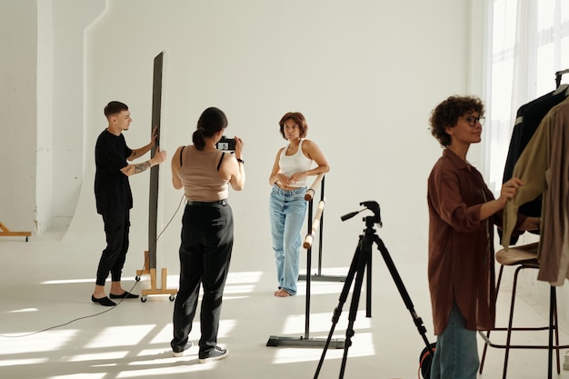 Long shot of shooting team carrying out their work during photo session