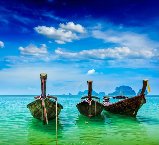 Long tail boats on tropical beach Krabi Thailand