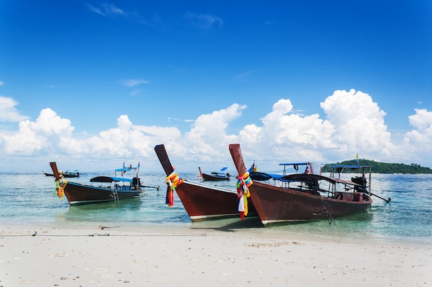 long tail boats on tropical beach