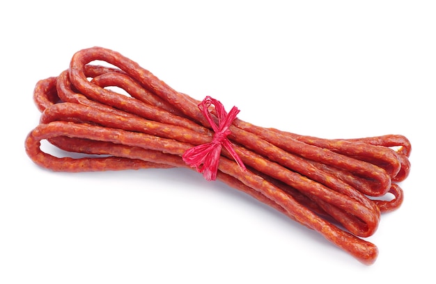 Long thin dry sausage on white background