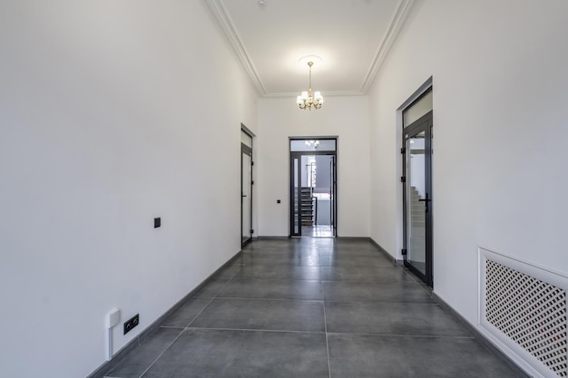 Long white empty corridor in interior of entrance hall of\
modern apartments office or clinic