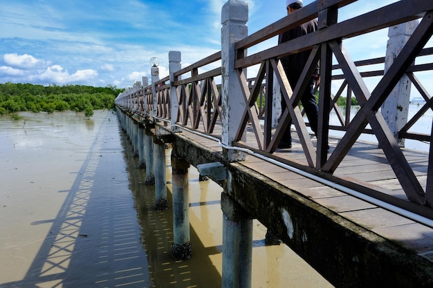 Long wooden Bridge with flooding water below in Malaysia