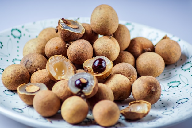 Longan fruit  in a plate, on  white  background. 