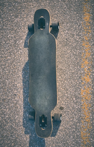 Longboard on asphalt without people evening photo