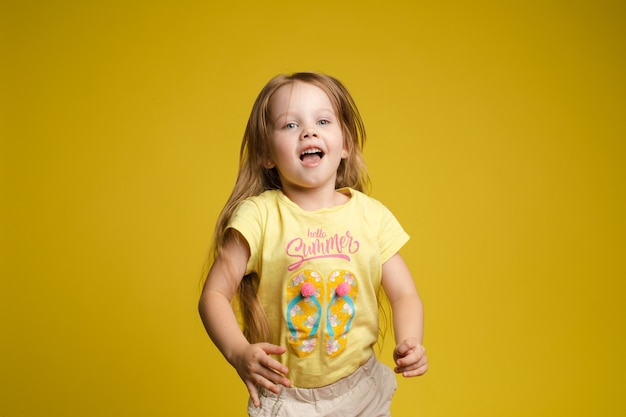 Longhaired girl in cute shirt playing with hair and twirling