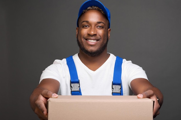 Photo longshoreman in baseball cap holds forward empty box transfers for packing goods