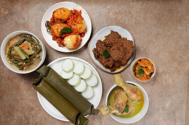 Lontong Lebaran served with sambal goreng opor ayam sayur labu siam rendang and telur balado