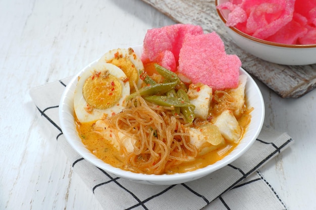 lontong sayur- Compressed rice cake served with curry coconut milk sauce and vegetables and