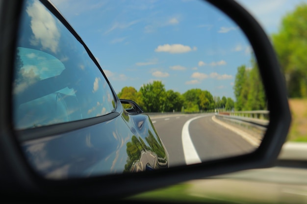 Look back through side mirror of sportscar