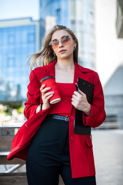 The look of a confident female financial manager is walking on a modern street in business clothes a successful professional woman Business concept woman boss