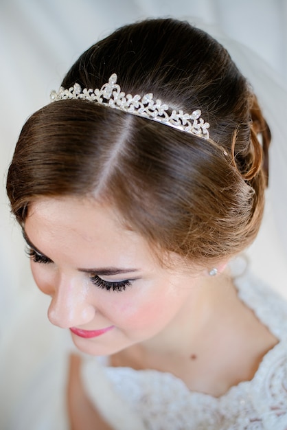 Look from above at bride's hair-do decorated with pearl crown