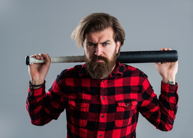 Look menacing brutal bearded man using baseball bat for fighting man swung the bat bandit gang and conflict sport street hooligan with bat man reliving stress emotion control concept