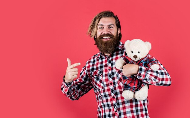 Look at this Guy with happy face plays with soft toy Childish mood concept guy enjoy valentines day best present ever Valentines day gift for beloved Holiday celebration concept