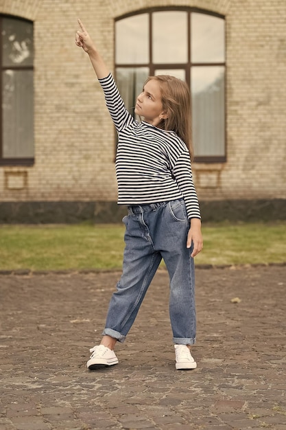 Look at this Little child pointing finger up urban outdoors Pointing gesture Marketing and advertising Sales and distribution Displaying information Clothing shop Childrens clothes