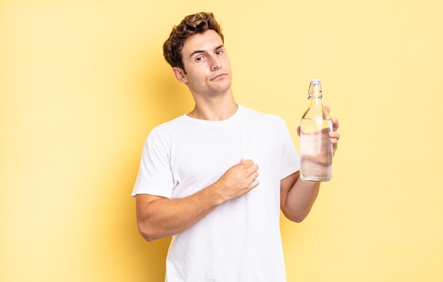 Looking arrogant, successful, positive and proud, pointing to self. water bottle concept