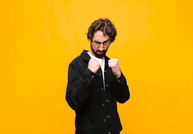 Looking confident, angry, strong and aggressive, with fists ready to fight in boxing position