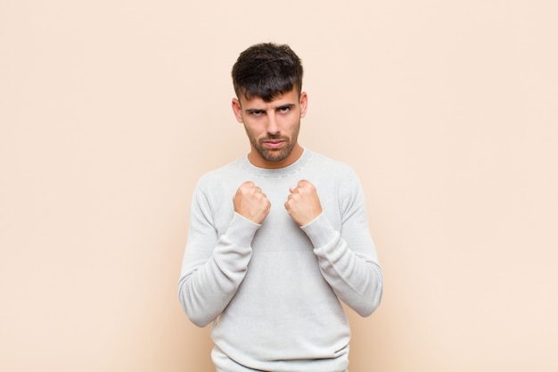 looking confident, angry, strong and aggressive, with fists ready to fight in boxing position