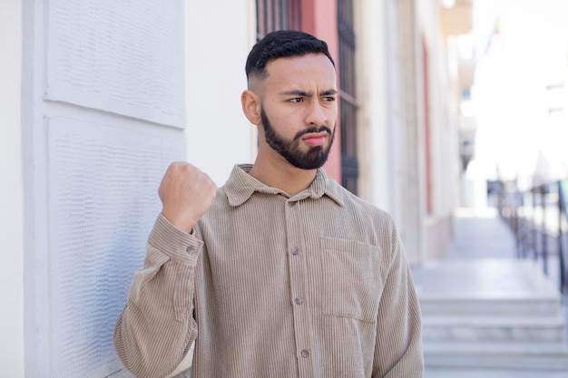 Looking confident angry strong and aggressive with fists ready to fight in boxing position