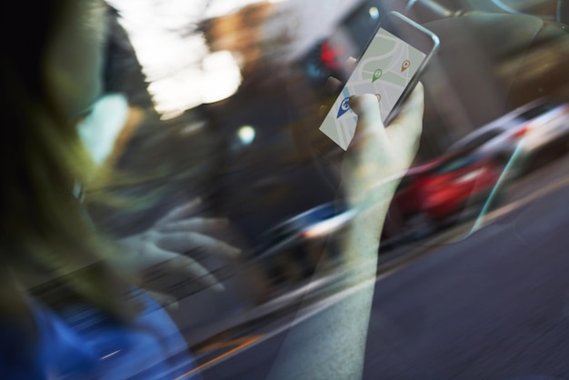 Looking for directions Theres an app for that Cropped shot of a woman using her phones gps while driving