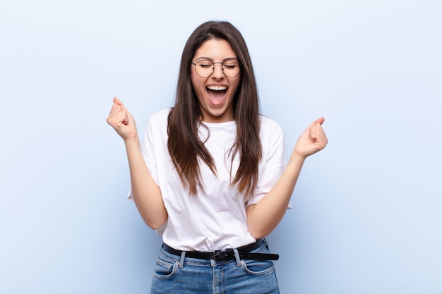 looking extremely happy and surprised, celebrating success, shouting and jumping