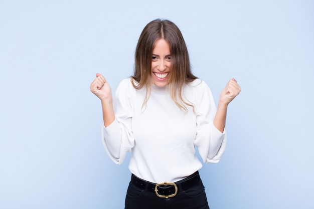 looking extremely happy and surprised, celebrating success, shouting and jumping