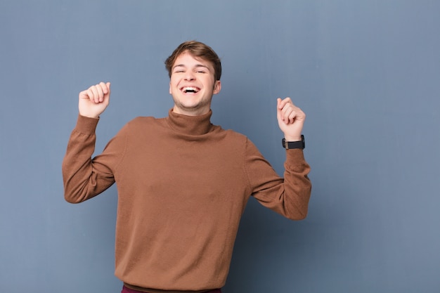 looking extremely happy and surprised, celebrating success, shouting and jumping