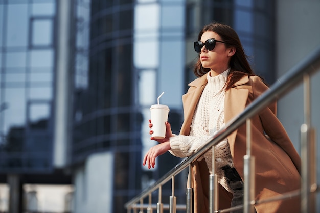 Looking far away. Young beautiful girl in warm clothes have walk in the city at her weekends time