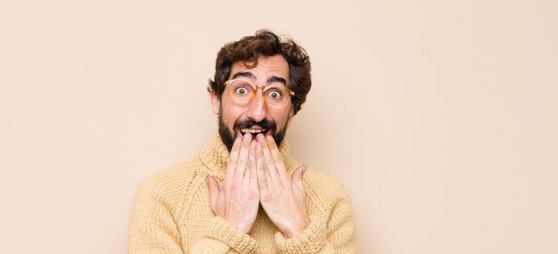 looking happy, cheerful, lucky and surprised covering mouth with both hands